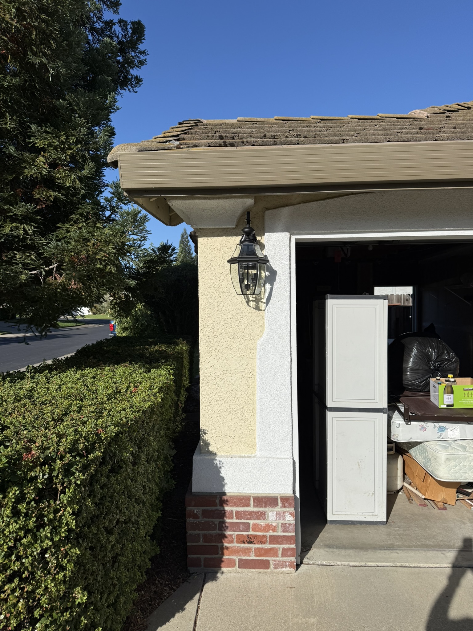 Outdoor wall light beside a garage at the Roseville fixture-replacement project